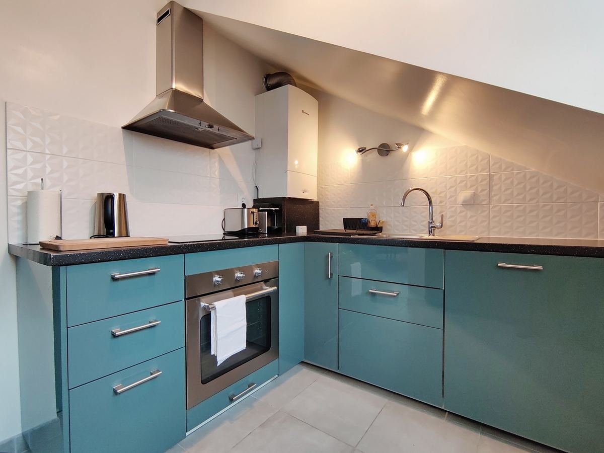 Cuisine équipée bleu canard avec four, hotte, plaque à induction et grille-pain